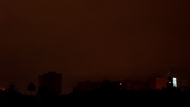 view-from-the-window-to-the-stormy-sky.-night-outside,-outside-the-window-dressed-with-rains-and-lightning-flashed.-seen-from-the-window-high-houses-FullHD