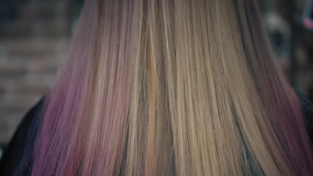 Closeup-down-up-view-on-dyed-pink-and-blonde-woman's-hair-in-hair-salon.-Back-view