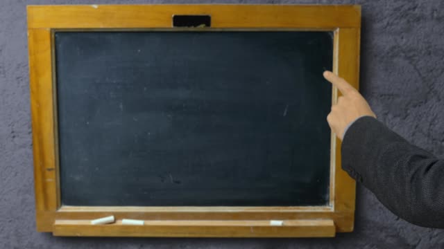 Man-hand-pointing-with-index-finger-on-blackboard-school