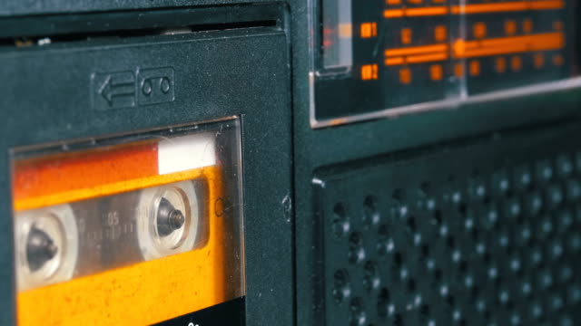 The-Vintage-Yellow-Audio-Cassette-in-the-Tape-Recorder-Rotates