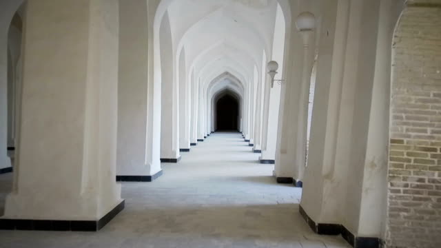 Arched-hallway-perspective-at-Mir-i-Arab-medressa-in-Bukhara,-Uzbekisan.