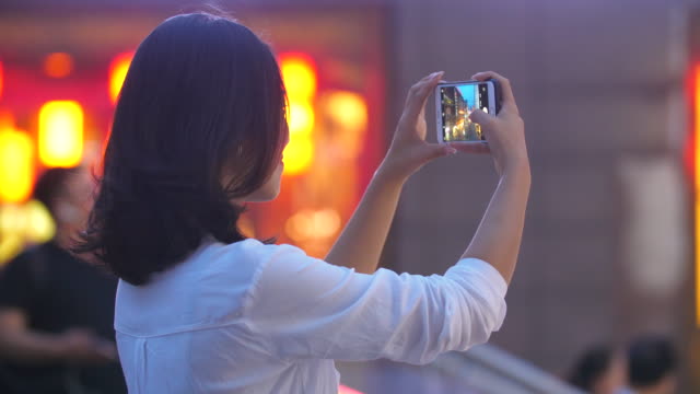Pretty-young-woman-using-phone-taking-picture