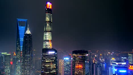 Shanghai's-three-tallest-skyscrapers,-the-Shanghai-World-Financial-Center,-the-Jin-Mao-Tower,-and-the-Shanghai-Tower-at-night