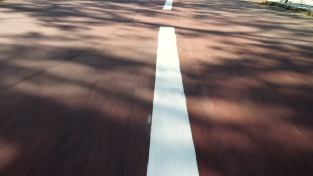 Slow-Motion-Shot:-Close-up-red-road-and-moving-following-the-way