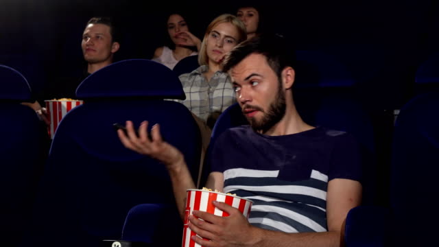 Man-talking-on-his-phone-at-the-movie-theatre