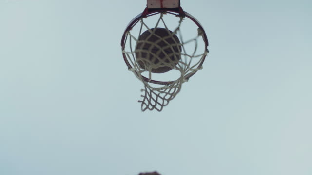 Basketball-going-through-outdoor-basketball-hoop