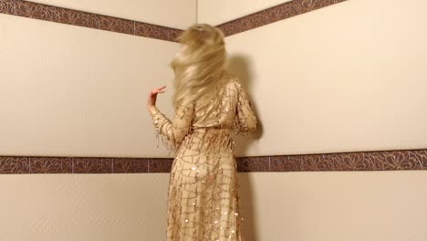 Portrait-of-a-woman-in-a-long-gold-dress,-with-long-blonde-fluttering-hair.