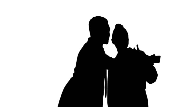 Silhouette-Two-doctors-are-making-selfie-using-a-smartphone-and-smiling