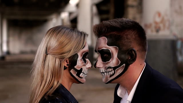 Close-up-of-the-face-of-a-couple-with-Halloween-makeup-in-the-form-of-a-skeleton