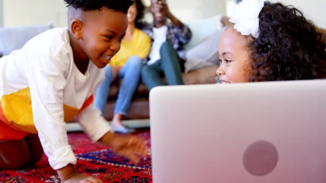 Front-view-of-cute-black-kids-having-fun-in-living-room-at-comfortable-home-4k