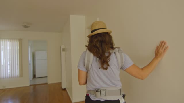 Woman-with-baby-checking-out-a-new-apartment