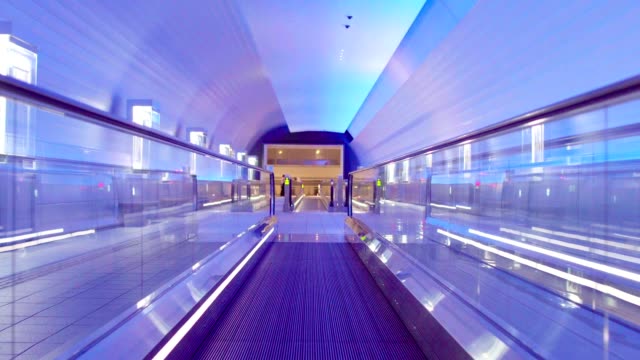 Illuminated,-empty,-multi-colored-moving-walkway