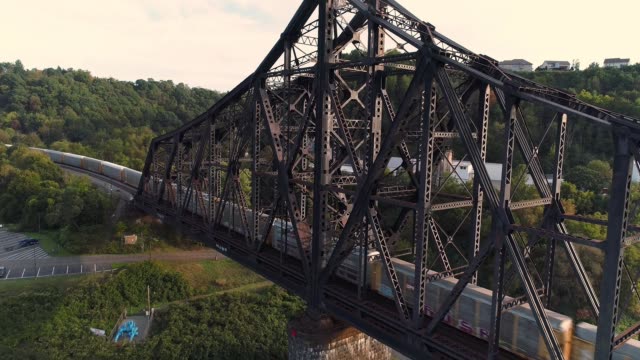 Rising-Aerial-Establishing-Shot-of-Coal-Train-on-Railroad-Bridge