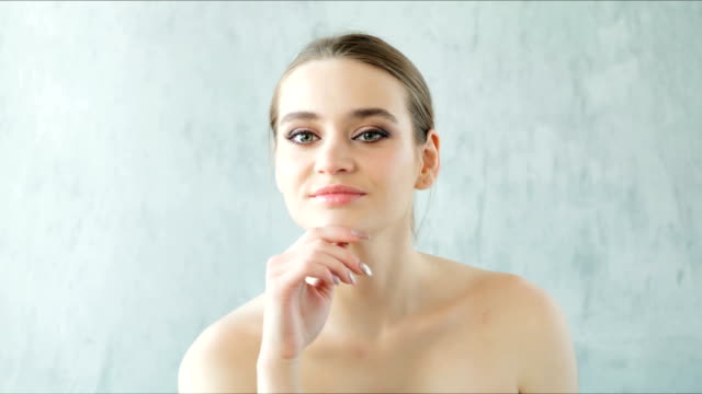 Beautiful-woman-posing-and-touching-her-healthy-skin-and-bare-shoulders.-Skincare-concept