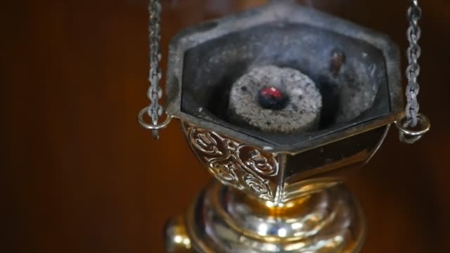 Smoking-device-in-the-middle-of-the-ritual.-Close-up-slow-motion-footage-of-a-smoking-device-in-the-middle-of-the-ritual-in-the-middle-of-the-church