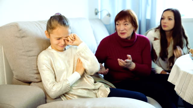 Little-girl-crying-while-mom-and-granny
