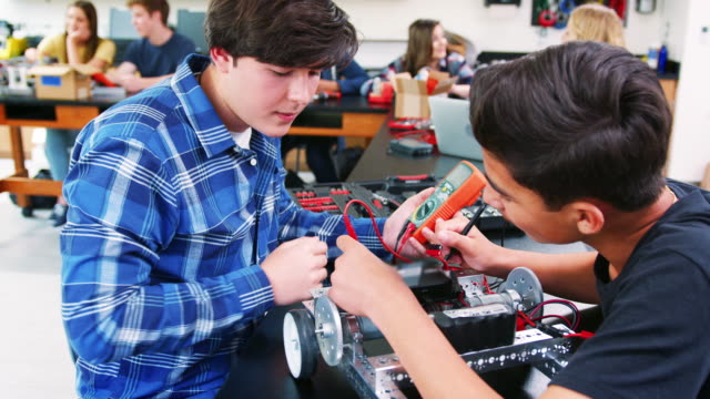 Male-High-School-Pupils-Building-Robotic-Vehicle-In-Science-Lesson