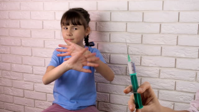 A-little-girl-is-injected-with-a-syringe
