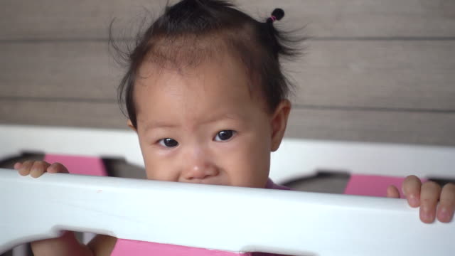 Asian-baby-girl-is-crying-on-baby-cot.