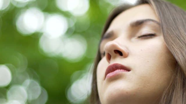 Woman-face-with-closed-eyes-contemplating-meditating-low-angle-place-for-ad-text