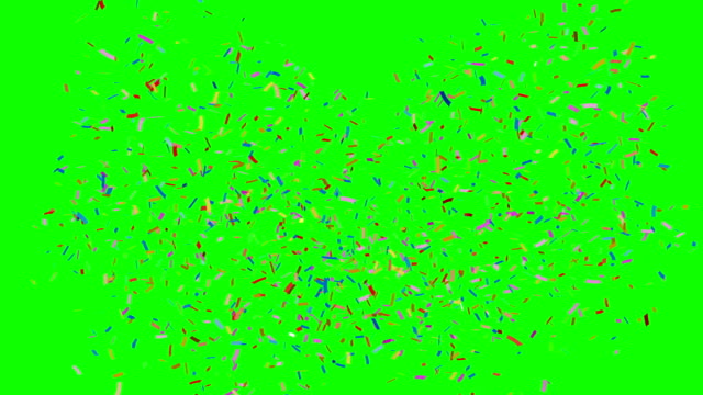 Multi-farbige-Konfetti-fällt-auf-grün.