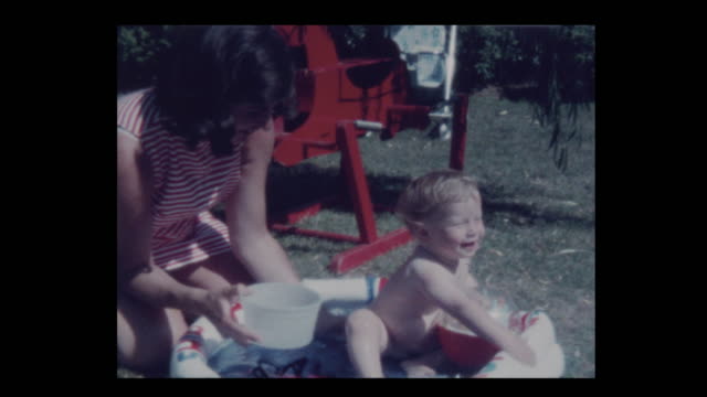 1971-Mother-plays-with-naked-infant-son-in-kiddie-pool