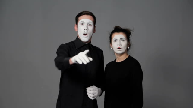 Scared-mime-artists-man-and-woman-on-grey-background.