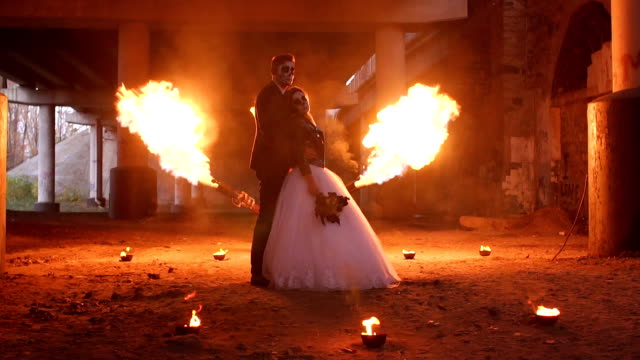 A-couple-of-newlyweds-at-a-Halloween-party,-a-huge-flame-flares-up-near-them.