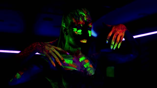 Beautiful-young-sexy-girl-dancing-with-ultraviolet-paint-on-her-body.-Girl-with-neon-bodyart