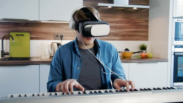 Young-man-learning-synthesizer-using-vr-lesson-tablet-application