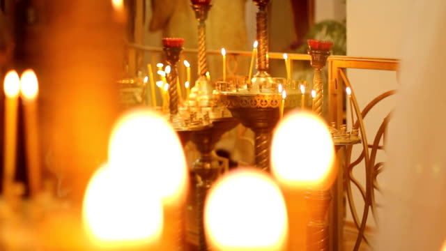 Bright-church-candle-lights-flickering,-illuminating-path-to-god-for-lost-souls