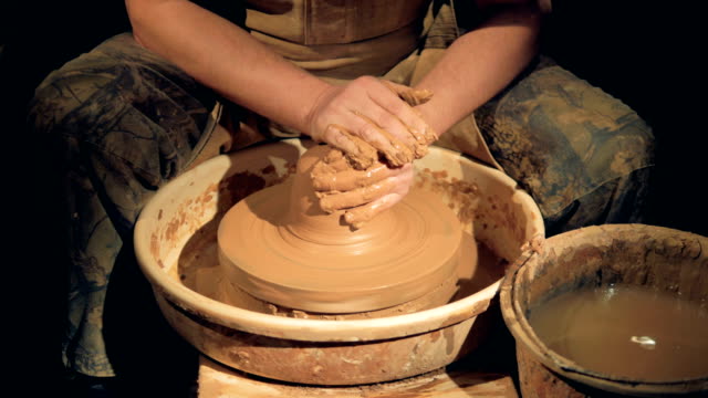 Potters-hands-get-washed-after-working-on-a-wheel.