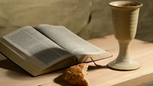 bible-with-chalice-and-bread,-panning,sliding
