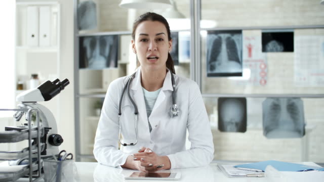 Female-Doctor-Talking-to-Camera-in-Clinic