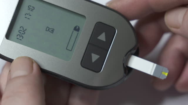 Patient-with-diabetes-using-blood-glucose-meter-to-test-blood-glucose