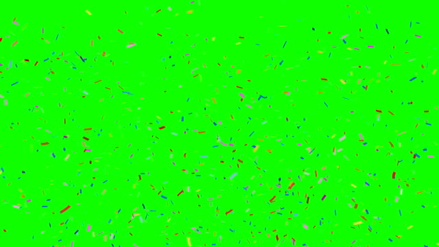 Multi-colored-confetti-falling-on-green.