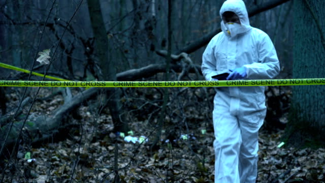 Forest-crime-scene,-forensic-science-expert-working-at-site,-evidence-collection