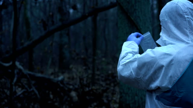 Forensic-science-expert-collecting-and-preserving-evidence-at-murder-site