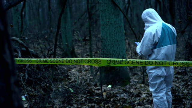 Forensic-science-expert-alone-at-crime-scene,-collecting-evidence,-murder-site