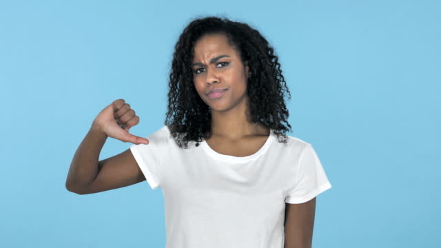 African-Girl-Gesturing-Thumbs-Down-Isolated-on-Blue-Background