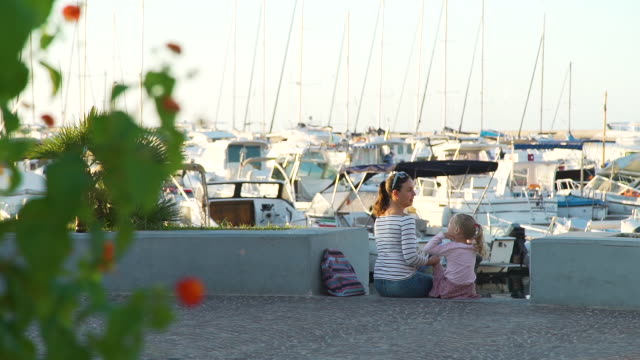 Woman-Tourist-Talking-with-Daughter-in-Marina