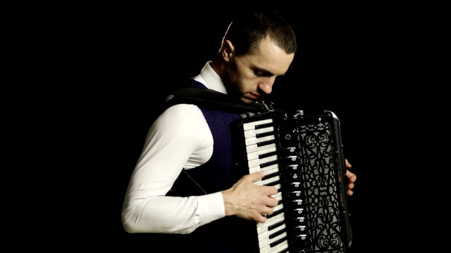 A-musician-in-a-white-shirt-plays-the-accordion.