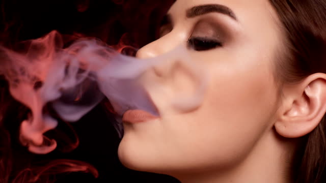 Glamour-seductive-gorgeous-brunette-woman-smoking-electronic-cigarette