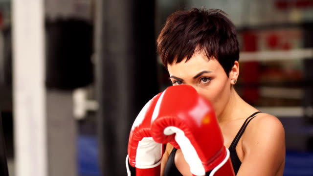Girl-boxer-trains-in-red-gloves-close-up