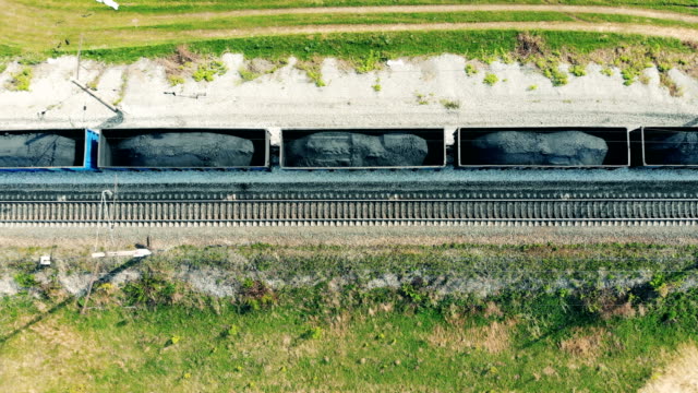 Carriages-with-coal-go-on-a-railroad,-top-view.