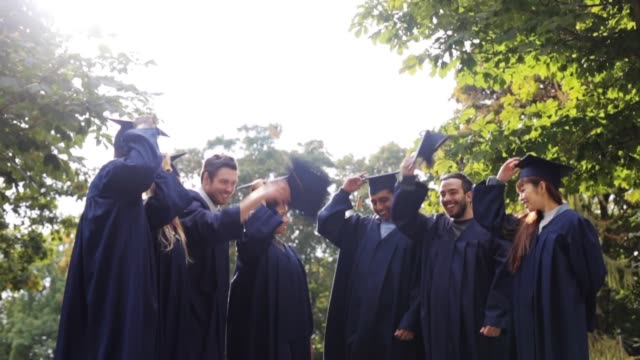 happy-students-throwing-mortar-boards-up