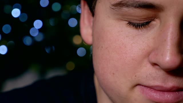 sad-depressed-young-man-starting-crying,-Christmas--half-face