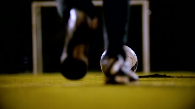 Man-in-sneakers-and-black-sweatpants-kicks-the-ball,-but-misses-the-goal