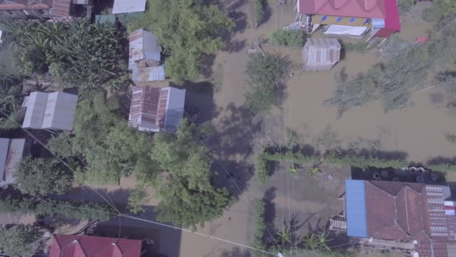 Aerial-vertical-shot-looking-down-over-worst-flooding-ravaging-Southeast-Asia,-drowning-villages-in-rural-area