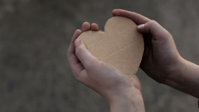 homeless-boy-holding-a-cardboard-heart